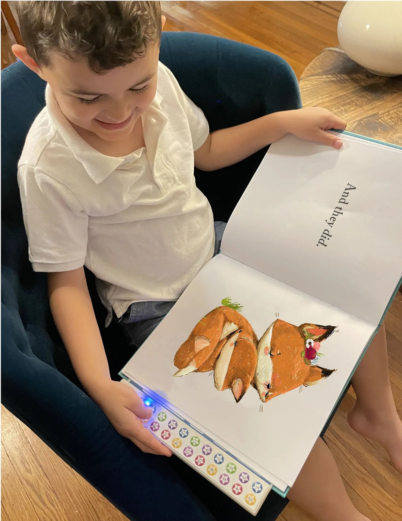 Child enjoying The Read To Me: Recordable Book Buddy, featuring colorful illustrations and interactive audiobook buttons.